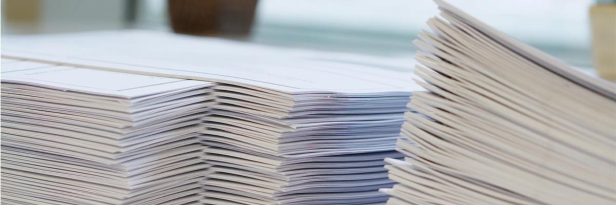 stacks of collated paper on desk