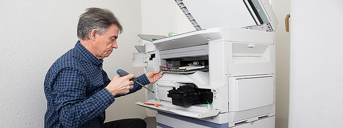 Man Fixing Multifunction Printers in Brockton MA