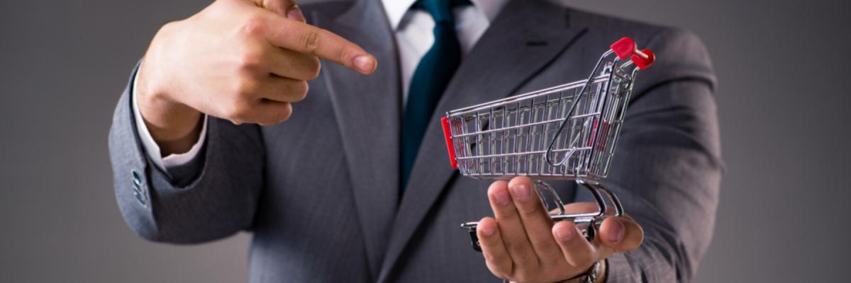 businessman holding small shopping cart, shopping concept