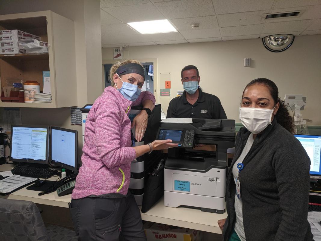 Signature Healthcare nurses examine new document generation equipment
